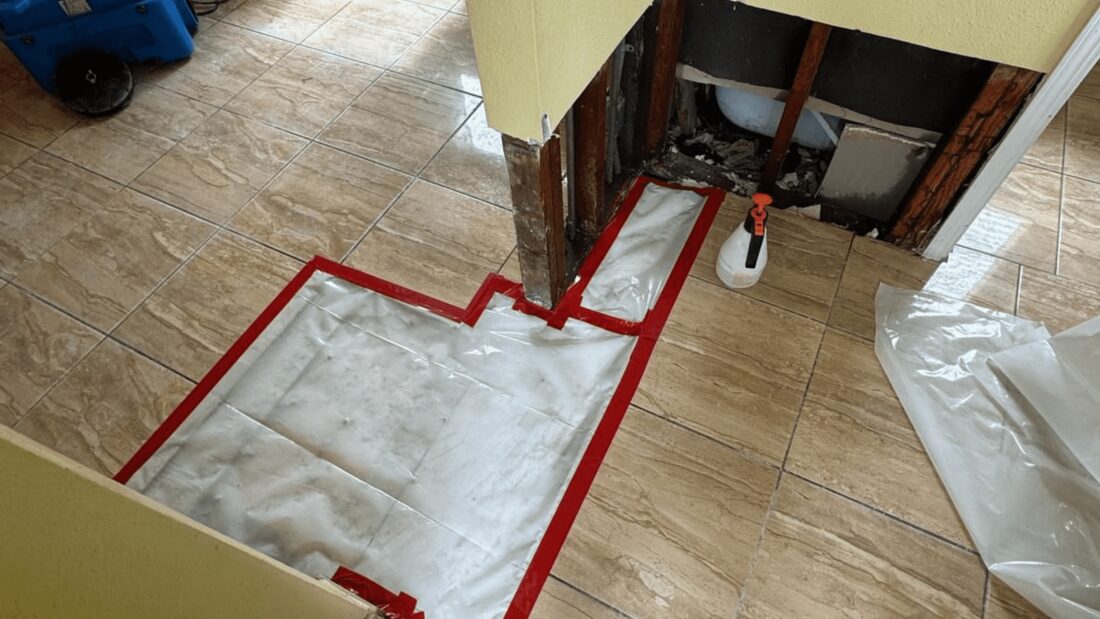 Floor containment and opened wall during water damage repair